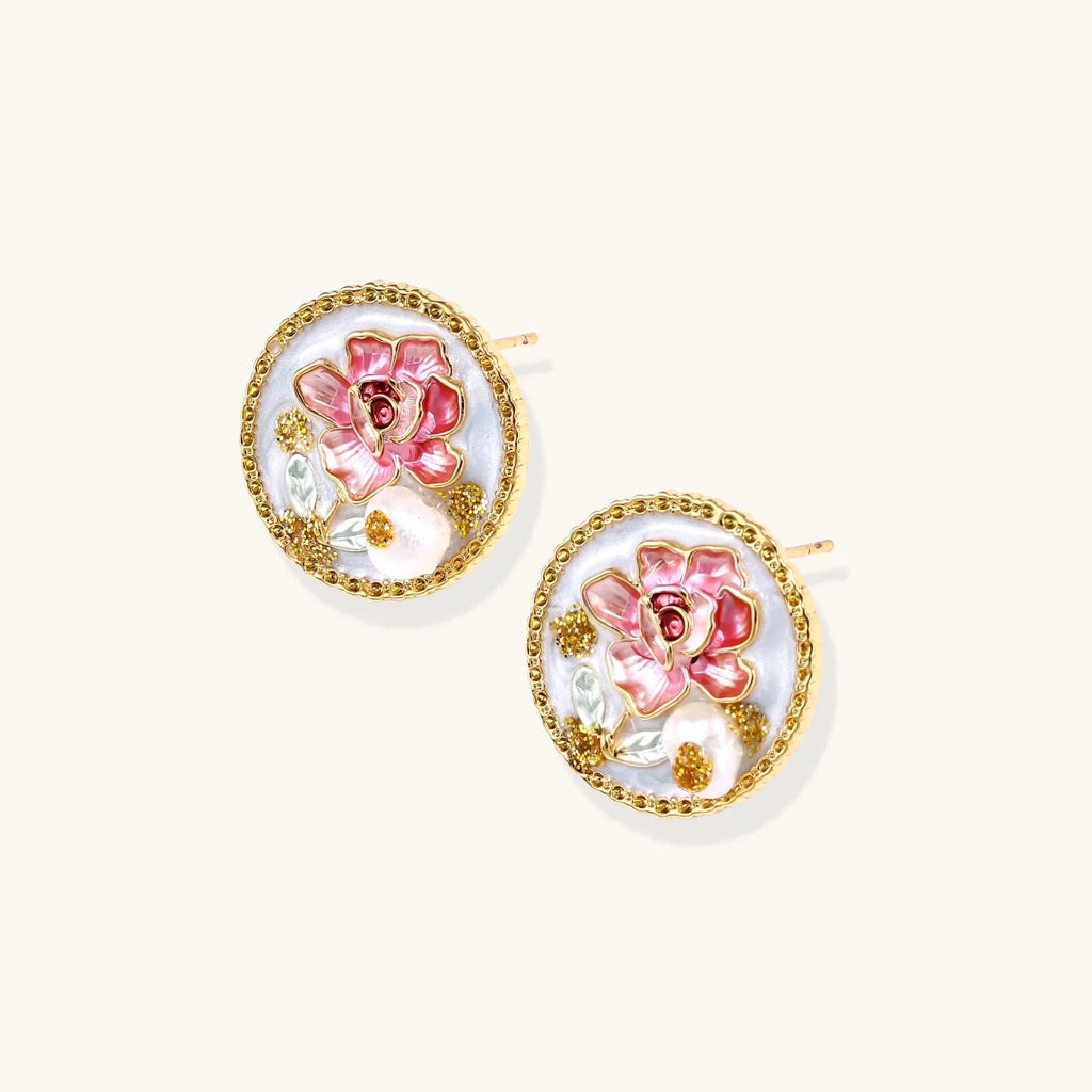 Gold-rimmed circular stud earrings with hand-painted pink peony enamel and pearl accents on white background