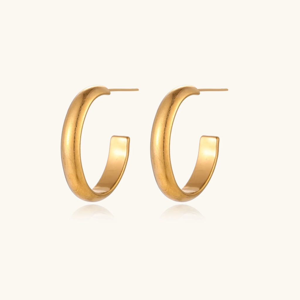 Chunky brushed gold hoop earrings in 14K plated stainless steel on cream background, front and side view.